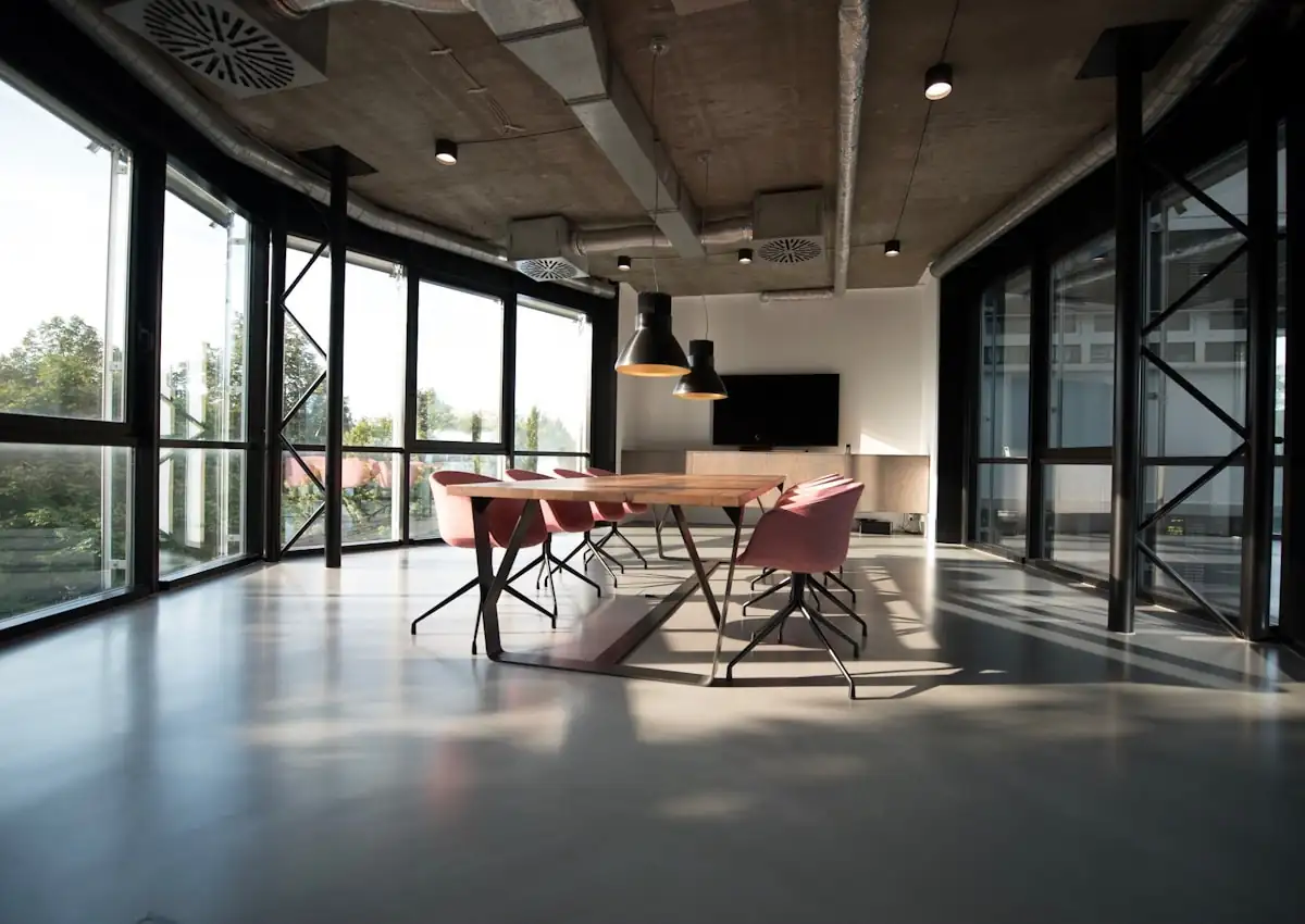 Open plan office floor with desks and plants