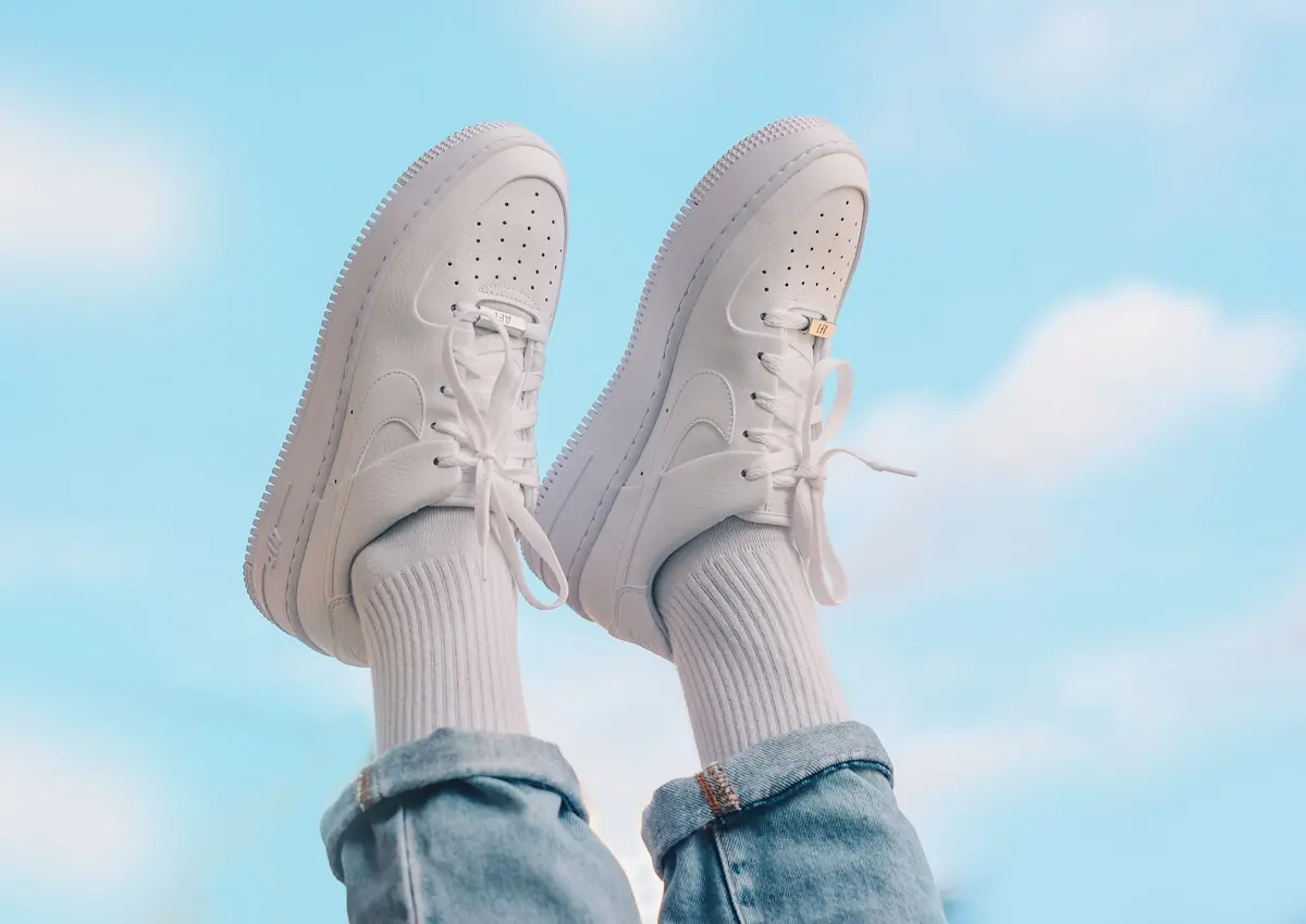 Blush low top sneakers worn with cropped jeans