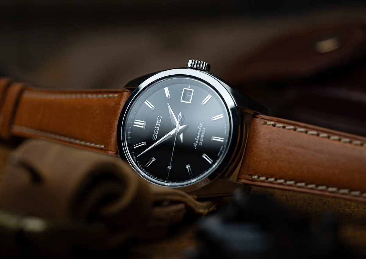 Automatic watch with black dial and tan leather strap