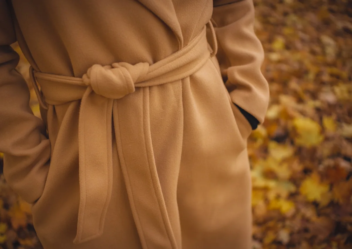 Camel belted wool coat photographed outdoors